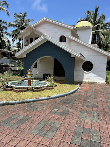 Private room with ceiling fan, comfortable bed, and stunning ocean view from window